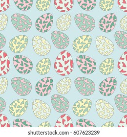 Delicate seamless pattern with random placed multicolored Easter eggs. Chicken eggs colored with hearts and placed on blue background. Light pastel colors. 