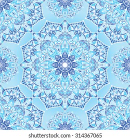 Delicate stylized winter background with mandalas. Vector seamless oriental ornament in blue tones. Bright ornate pattern for bedding.