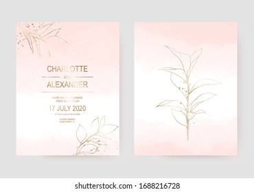 Delicate wedding invitation cards with gold leaf on pale pink watercolor texture.