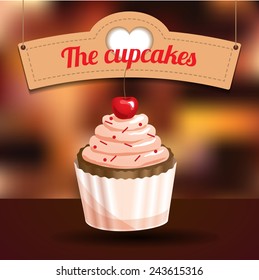Delicious cupcake with dessert cherry and sugar powder on blurred background