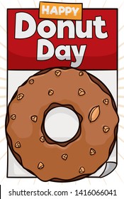 Delicious donut made with caramel cover and peanut sprinkles over a calendar with greeting message for a happy Donut Day celebration.