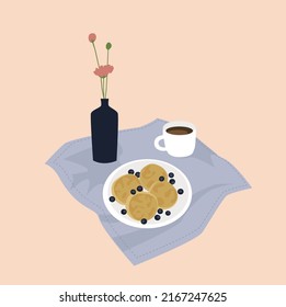 Delicious pancakes, berries, cup of coffe and vase on blue napkin. Tasty breakfast.