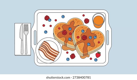 A delightful breakfast in bed setup featuring heart-shaped pancakes with berries and syrup, crispy bacon, orange juice, and cutlery on a white tray.