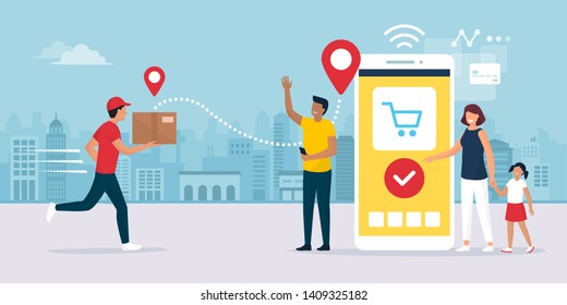 Delivery app service: man delivering a cardboard box to a happy cheerful family standing next to their smartphone, online shopping and logistics concept