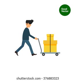 Delivery man carrying boxes on trolley