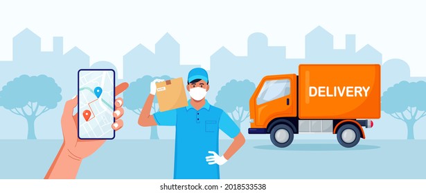 Delivery Man With Medical Protective Mask On His Face Holding Package With Yellow Truck On Background. Delivery During Quarantine Time. Safe Shipping Order. Online Delivery App On Phone Screen 