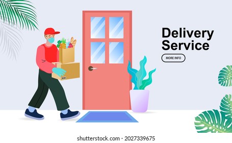 Delivery man red uniform with face mask holding box. Safe food delivery at home during coronavirus covid-19 epidemic delivery man holding a bag with fast food, he is wearing a face mask and gloves.