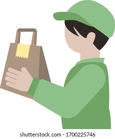 A delivery staff who is having a paper bag.