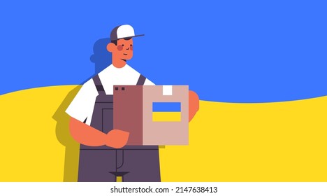 deliveryman holding help box with Ukraininan flag humanitarian aid material assistance governmental help