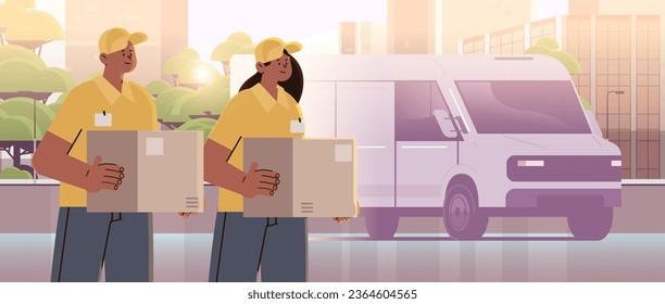 deliverymen holding cardboard boxes near delivery van couriers carrying parcels express delivery service happy labor day celebration