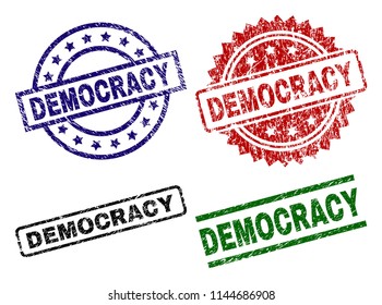DEMOCRACY seal prints with distress surface. Black, green,red,blue vector rubber prints of DEMOCRACY tag with scratched texture. Rubber seals with circle, rectangle, rosette shapes.