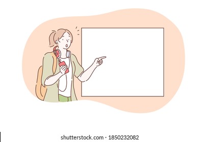 Demonstration, promotion, attention, advertisement concept. Young surprised frustrated girl cartoon character standing and pointing with finger at white blank placard with copy space for text 