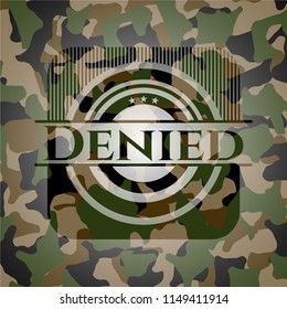 Denied written on a camo texture