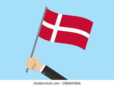 Denmark waving flag. Hand holding Danish flag. National symbol. Vector illustration. 