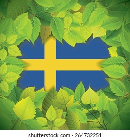 Dense, green leaves over the flag of Sweden