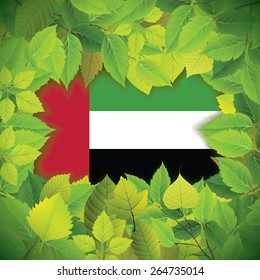 Dense, green leaves over the flag of the United Arab Emirates