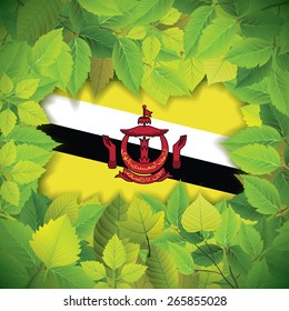Dense, green leaves over the flag of Brunei