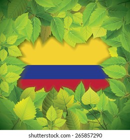 Dense, green leaves over the flag of Colombia