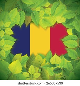 Dense, green leaves over the flag of Chad