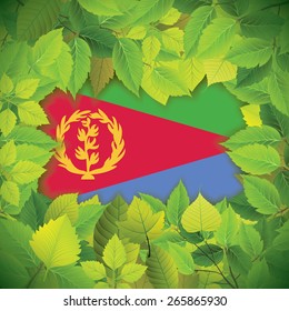 Dense, green leaves over the flag of Eritrea