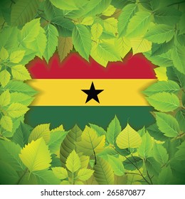 Dense, green leaves over the flag of Ghana