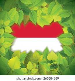 Dense, green leaves over the flag of Monaco