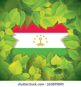 Dense, green leaves over the flag of Tajikistan