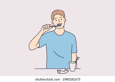 Dental hygiene and health concept. Young positive man cartoon character standing and cleaning teeth woth toothbrush and paste in bathroom vector illustration 