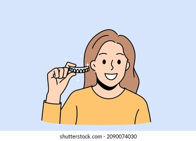 Dental hygiene and tooth care concept. Smiling positive woman standing holding and showing braces or whitening strips in hands vector illustration 