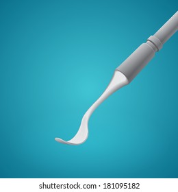 Dental spoon on blue background
