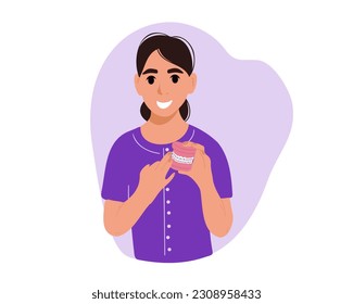 El dentista sostiene los dientes con cordones.
Concepto de alineación y corchetes ortodoncistas, ilustración vectorial