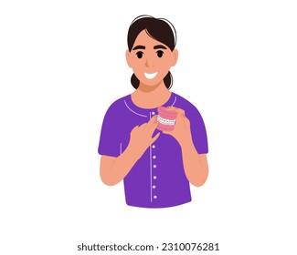 Dentist holds teeth with braces.
The concept of orthodontic alignment and braces, vector illustration