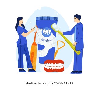 Dentist and nurse holding large toothbrushes alongside a giant toothpaste tube and denture model, emphasizing the importance of oral hygiene and promoting dental health awareness