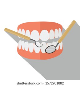 Dentures with dentist tool isolated with white background