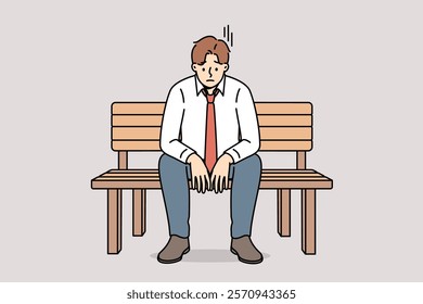 Depressed business man sitting on park bench and feeling sad about financial problems. Depressed guy needs psychotherapy to avoid falling into stress or apathy, which destroys personality