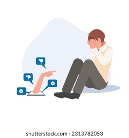 Depressed lonely young student man, a victim of Internet bullying, is sitting in front of a phone, covering his face with his hands.Victim of mass media, cyber-bullying, online violence