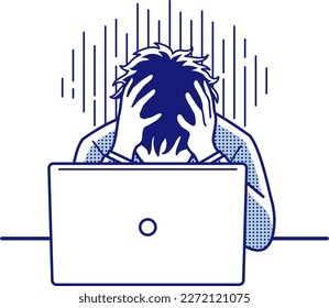 A depressed man holding his head in front of a computer