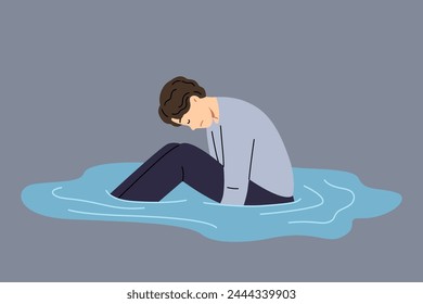 Depressed man sits in puddle of tears, feeling apathy after breaking up with girlfriend or being fired from job. States of apathy in guy in need of friendly support or help from psychologist