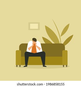 A depressed man sitting on the sofa