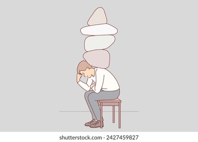 Depressed man with stones on back experiencing stress and discomfort due to heavy workload. Depressed guy feels stressed due to problems caused by unemployment and financial crisis