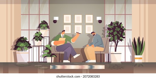 depressed man visiting psychologist male psychotherapist consulting patient during psychotherapy session mental health depression