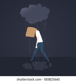 Depressed man walks in the rain with paper bag on his head