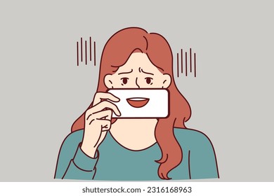 Depressed woman with fake smile hides emotions pretending to be extrovert and happy human. Depressed girl with talking mouth on phone screen symbolizes psychological problems and lack of own opinion.