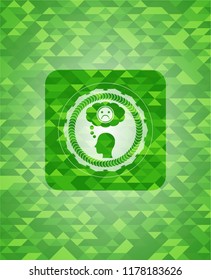 depression icon inside green emblem with triangle mosaic background