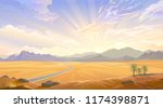 The desert view over the hill. Sunrise behind the mountains and a road across the desert.