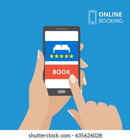 Design Concept Of Hotel Booking Online. Hand Holding Smartphone With Book Button And Bed Icon On Screen. Mobile Application For Renting Accommodations.