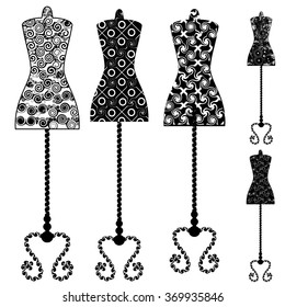 Design element. A set of mannequins in black and white with a pattern of swirls and lines patterned on a stand