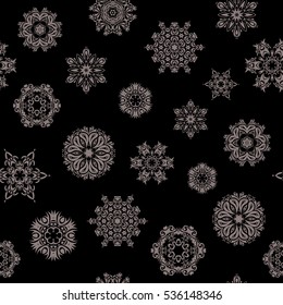 Design. Vector seamless pattern on black background for Christmas. Decorative beige snowflakes pattern.