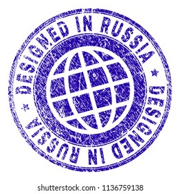 DESIGNED IN RUSSIA stamp watermark with grunge texture. Blue vector rubber print of DESIGNED IN RUSSIA tag with unclean texture. Seal has words placed by circle and planet symbol.