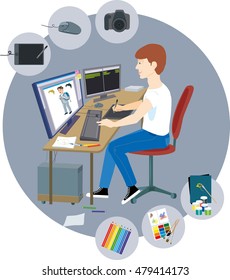 Designer man sitting at the computer and drawing on a graphic tablet 
